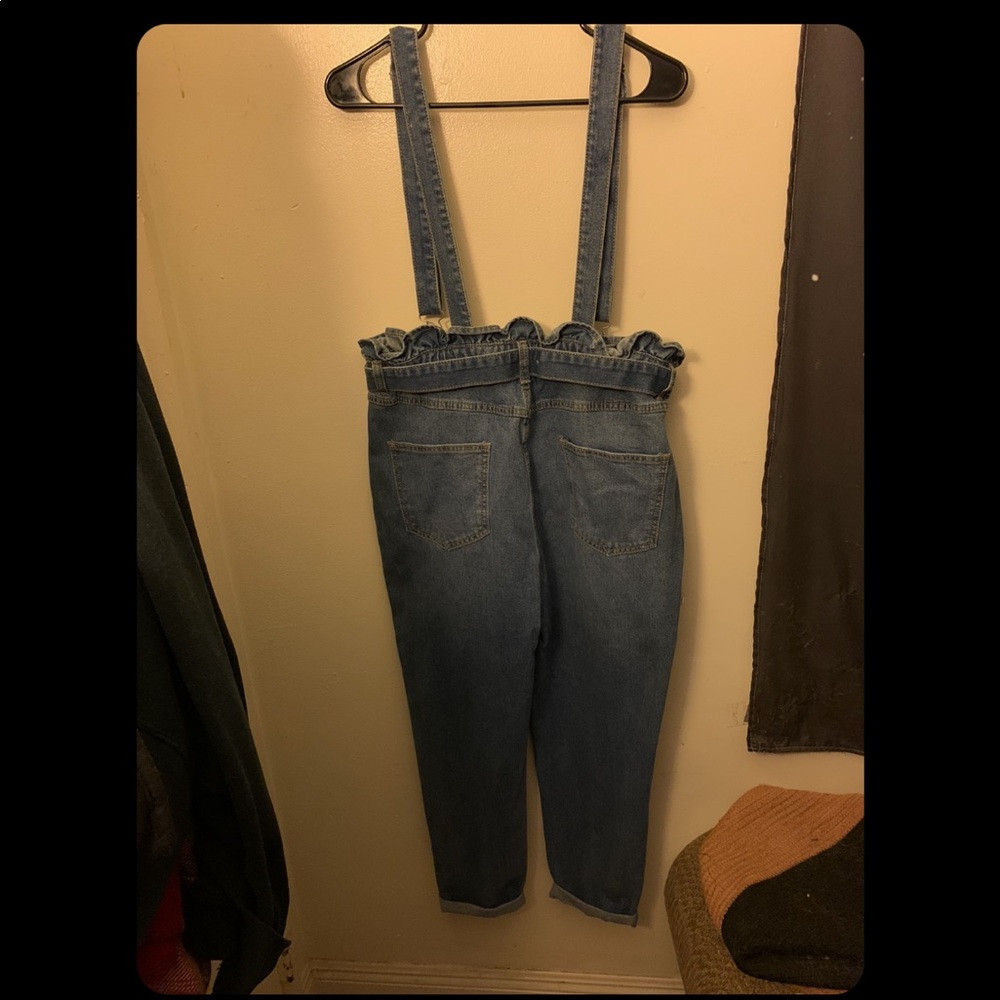 Oversized denim blue overalls. Not much stretch.
